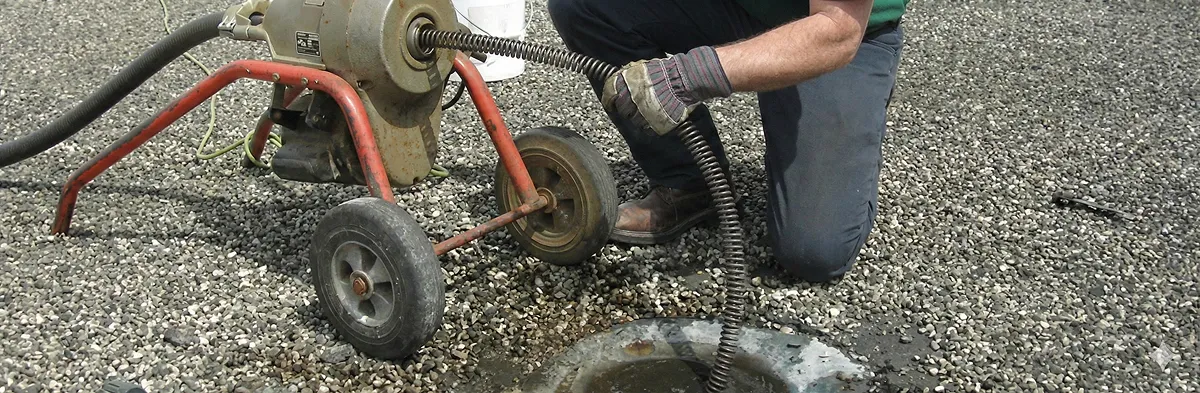 sewer rodding technician actively removing blockages from a sewer line in Bradenton, FL